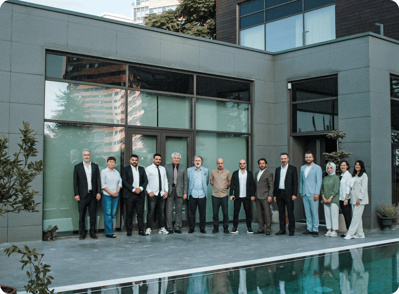 couple of people who is working at kalkavan global, in front of a villa with a pool